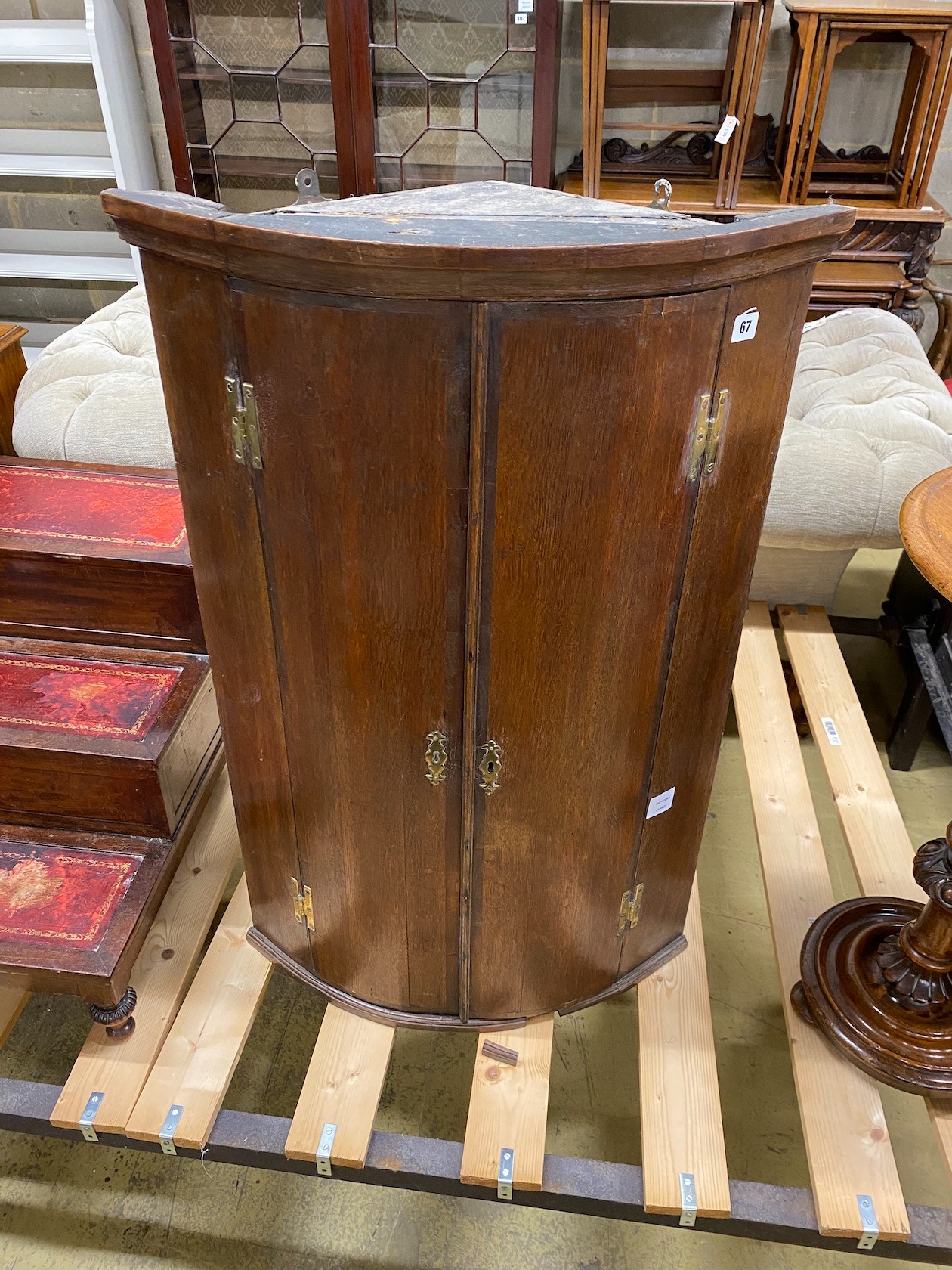 A George III oak bow front hanging corner cabinet, width 63cm, depth 40cm, height 98cm